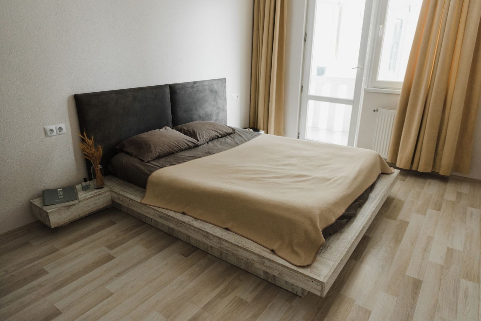 Cosy minimalist bedroom in neutral tones with soft natural light