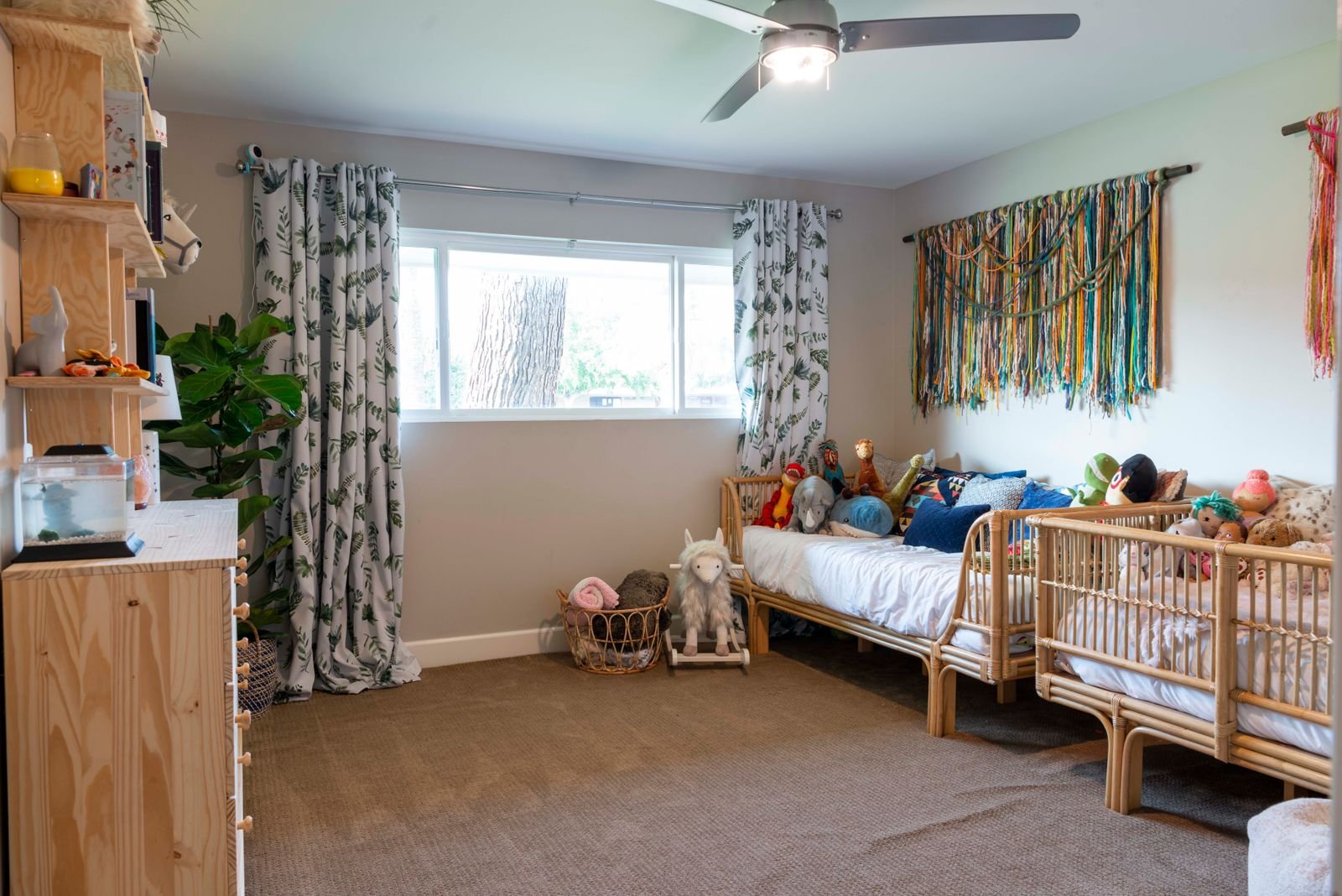 Bright bedroom with woven bed frames, a ceiling fan and colourful decor